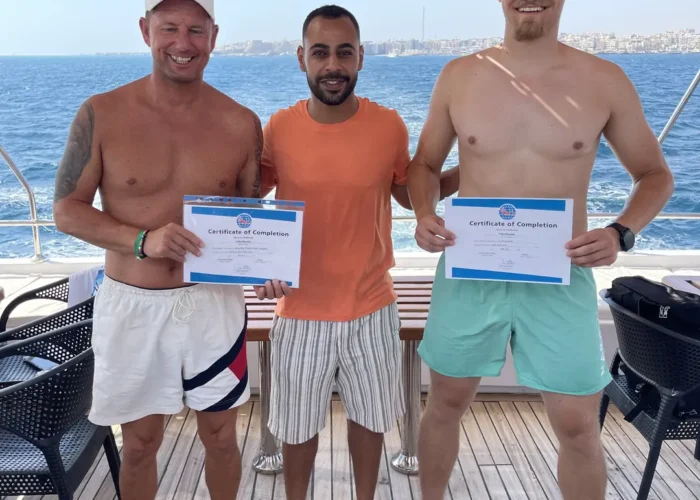 PADI Advanced Open Water Course in Hurghada - Happy students with their instructor on a diving boat, Red Sea