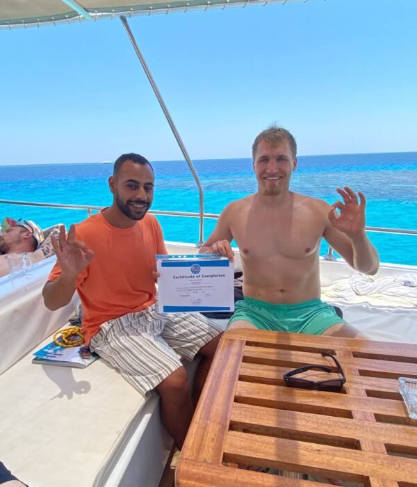 Diving Mentor - Student receiving PADI Certificate of Completion - Scuba Diving course in Hurghada
