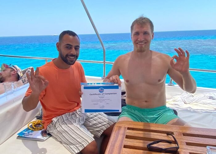 Diving Mentor - Student receiving PADI Certificate of Completion - Scuba Diving course in Hurghada