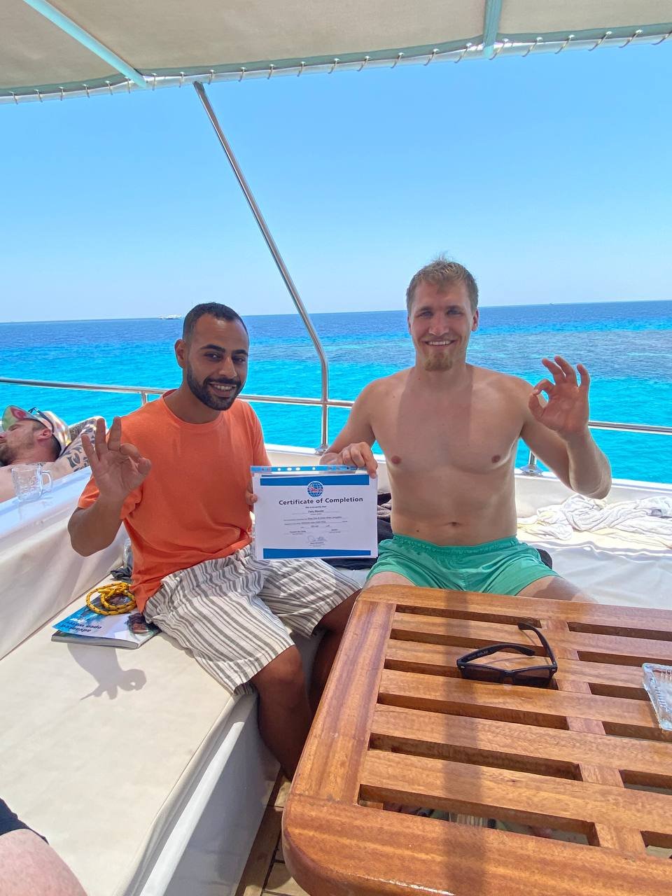 Diving Mentor - Student receiving PADI Certificate of Completion - Scuba Diving course in Hurghada